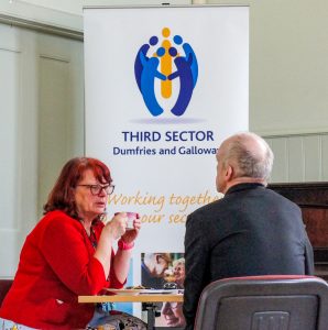 Engagement Officer Christine Clarke in a one-to-one at a support roadshow.
