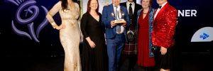 Adrian Turpin, artistic director, collects the award, with, to his left left, operations director Anne Barclay and Cathy Agnew, festival company chair, second right.