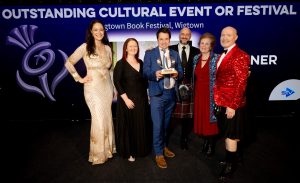 Adrian Turpin, artistic director, collects the award, with, to his left left, operations director Anne Barclay and Cathy Agnew, festival company chair, second right.